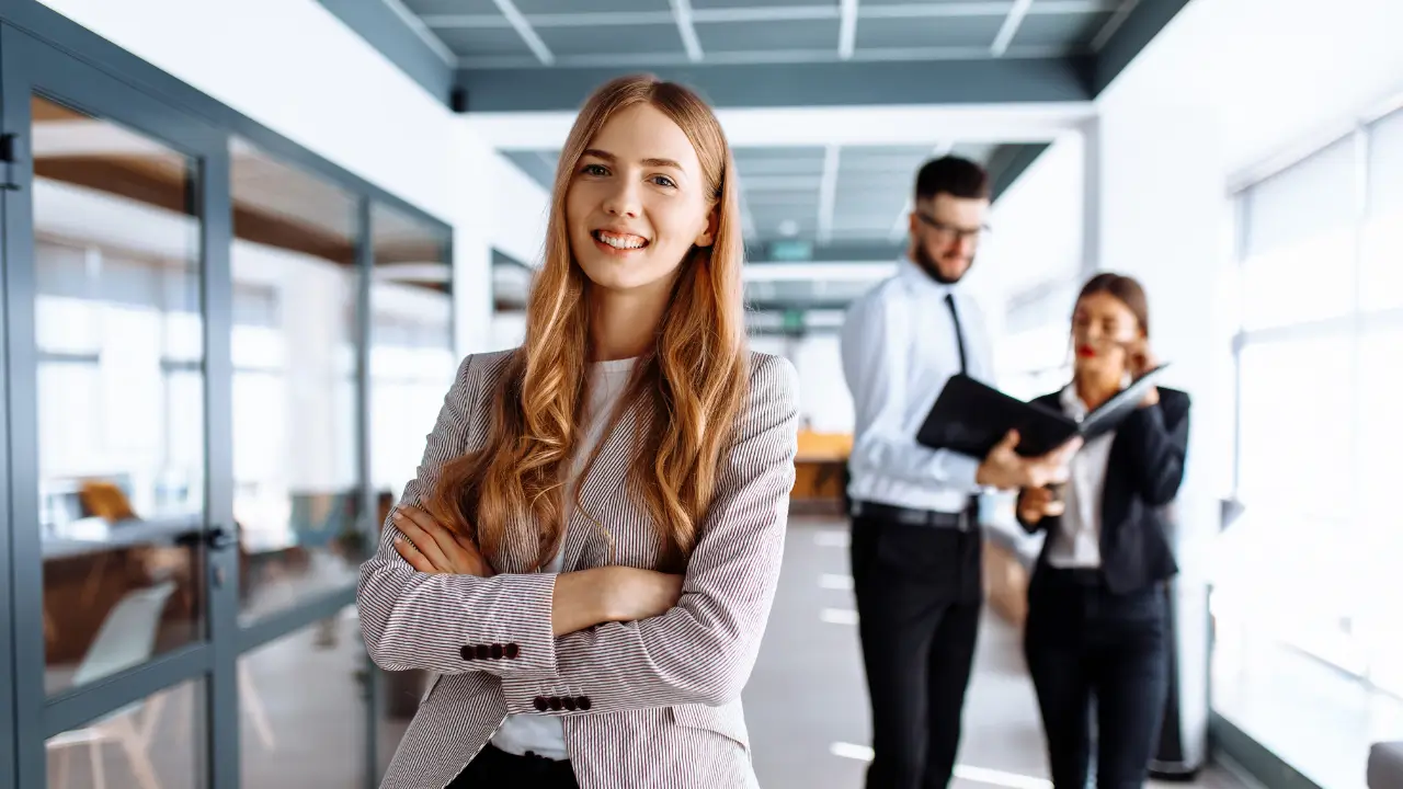 A female employee smiling confidently after being hired by the hiring manager.