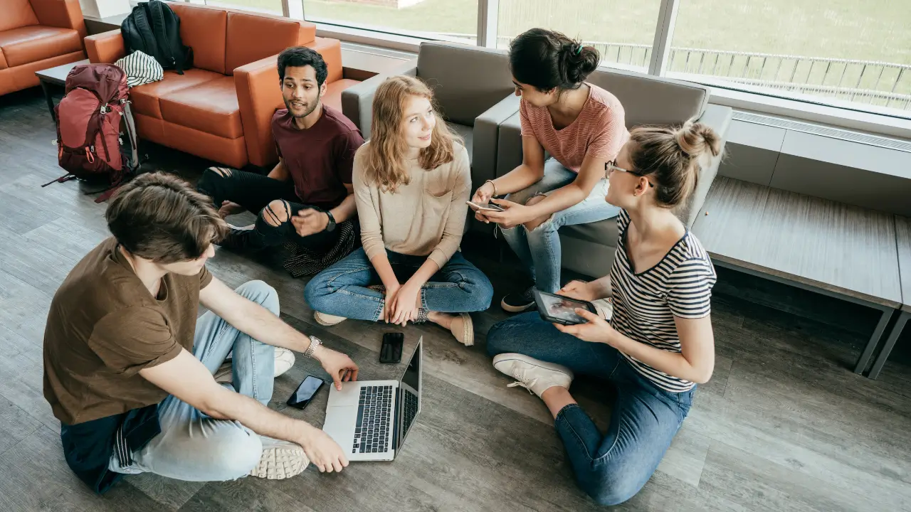 A group of college students having a discussion, demonstrating how they develop skills like collaboration.