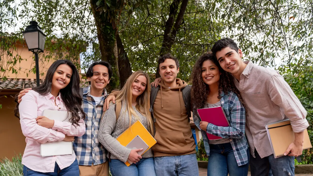 A group of college students smiling side by side for a photo 