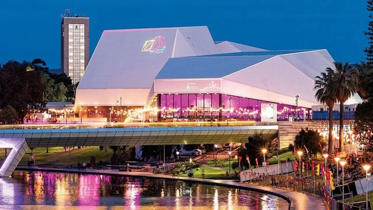 Exterior of Adelaide Festival Centre at night, lit up against the city backdrop, a central hub for arts and events.