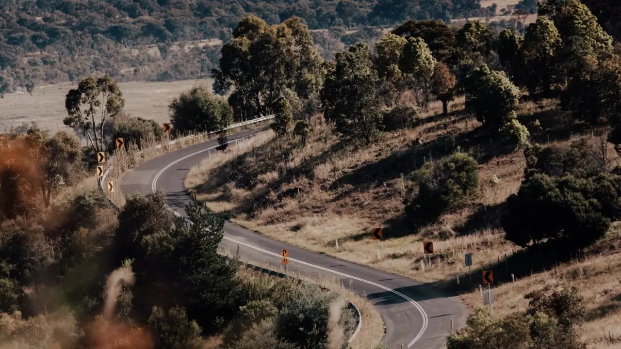 Winding road through the landscapes of Mount Stromlo Forest Park