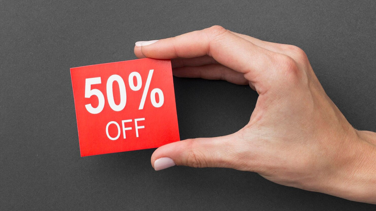 Hand holding 50% off tag