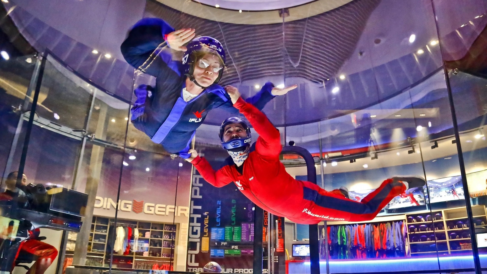 Two adult doing indoor skydiving