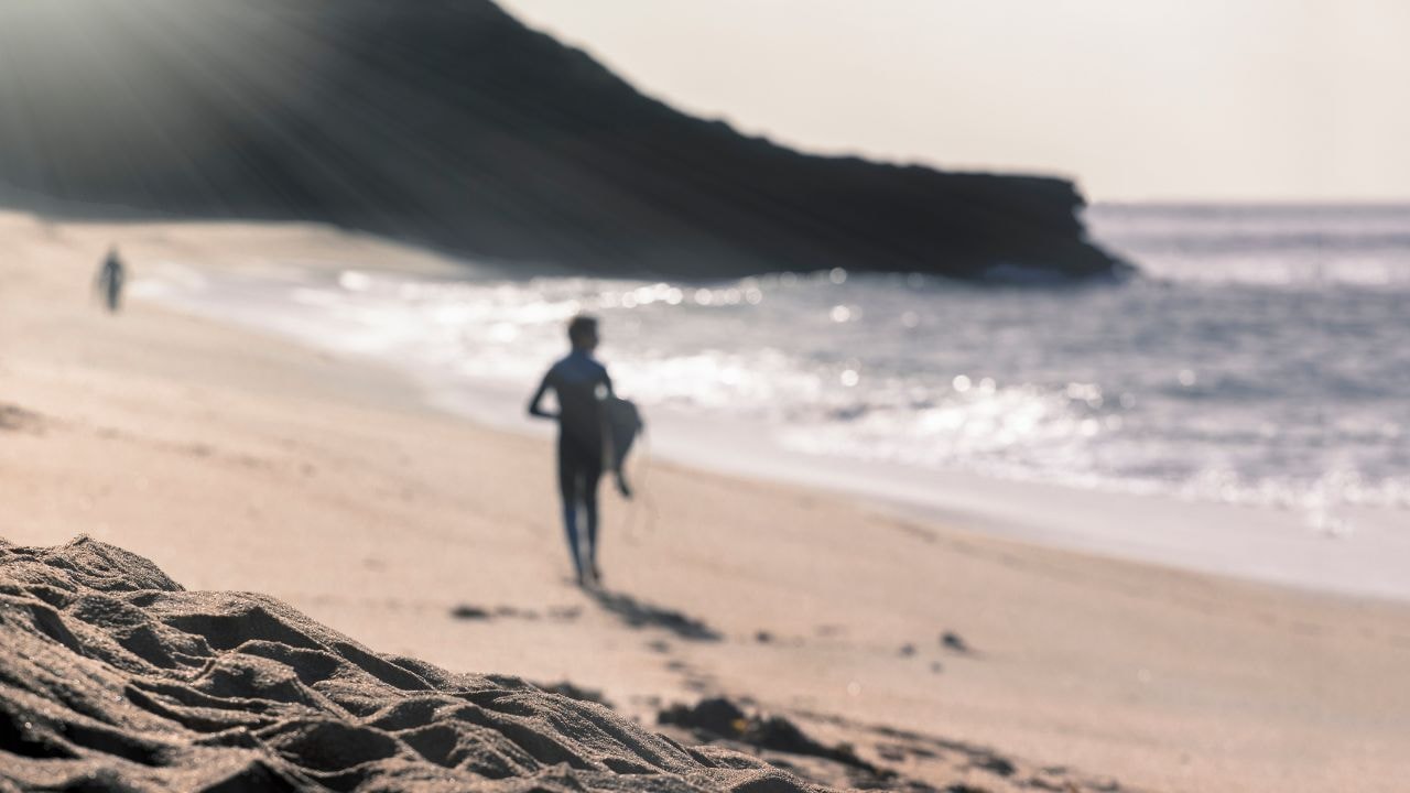  A surfer in the background at Bells Beach