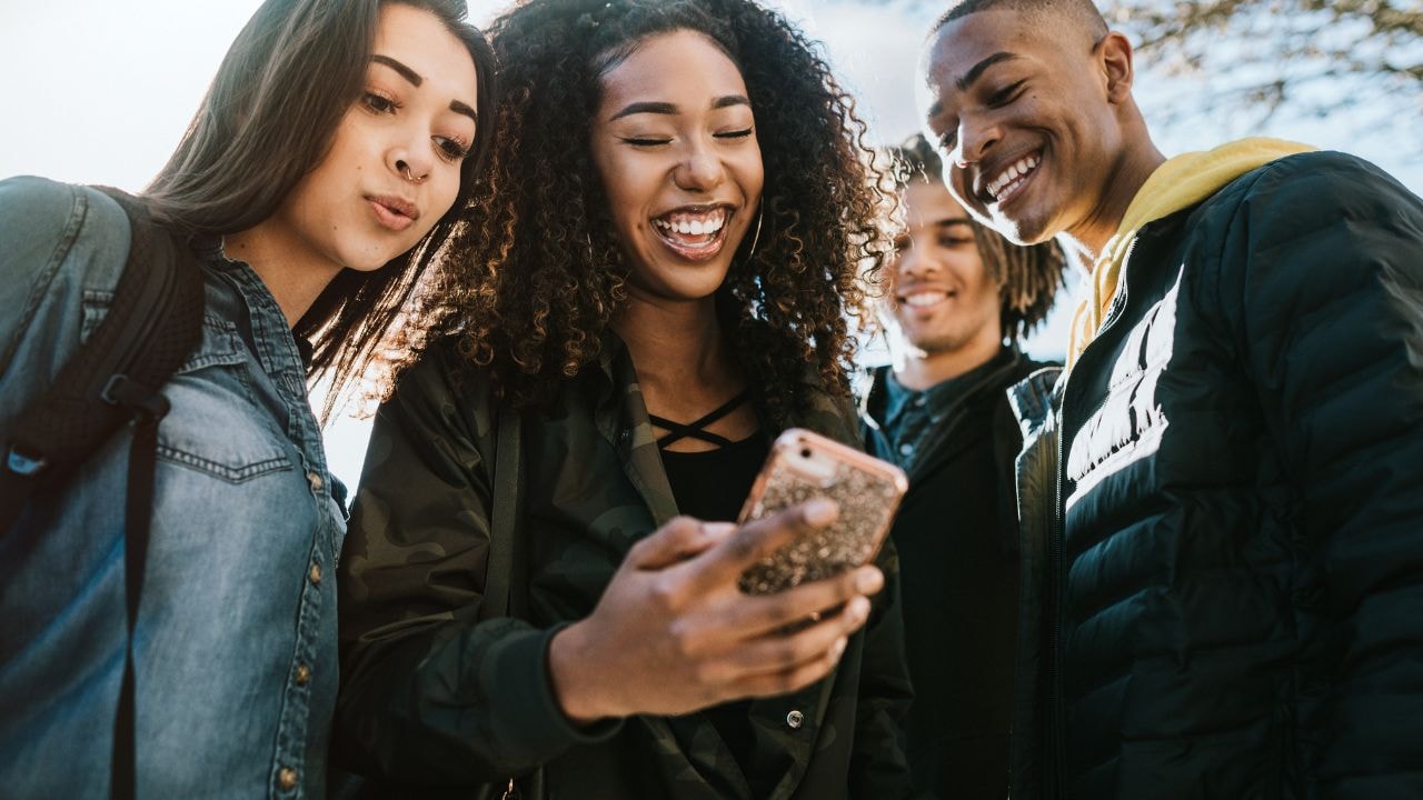 University students watching a video on a mobile phone